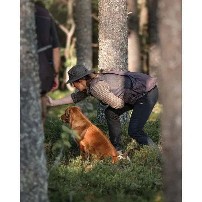 Mörk buckethat i skogsmiljö med hund - användningsfall